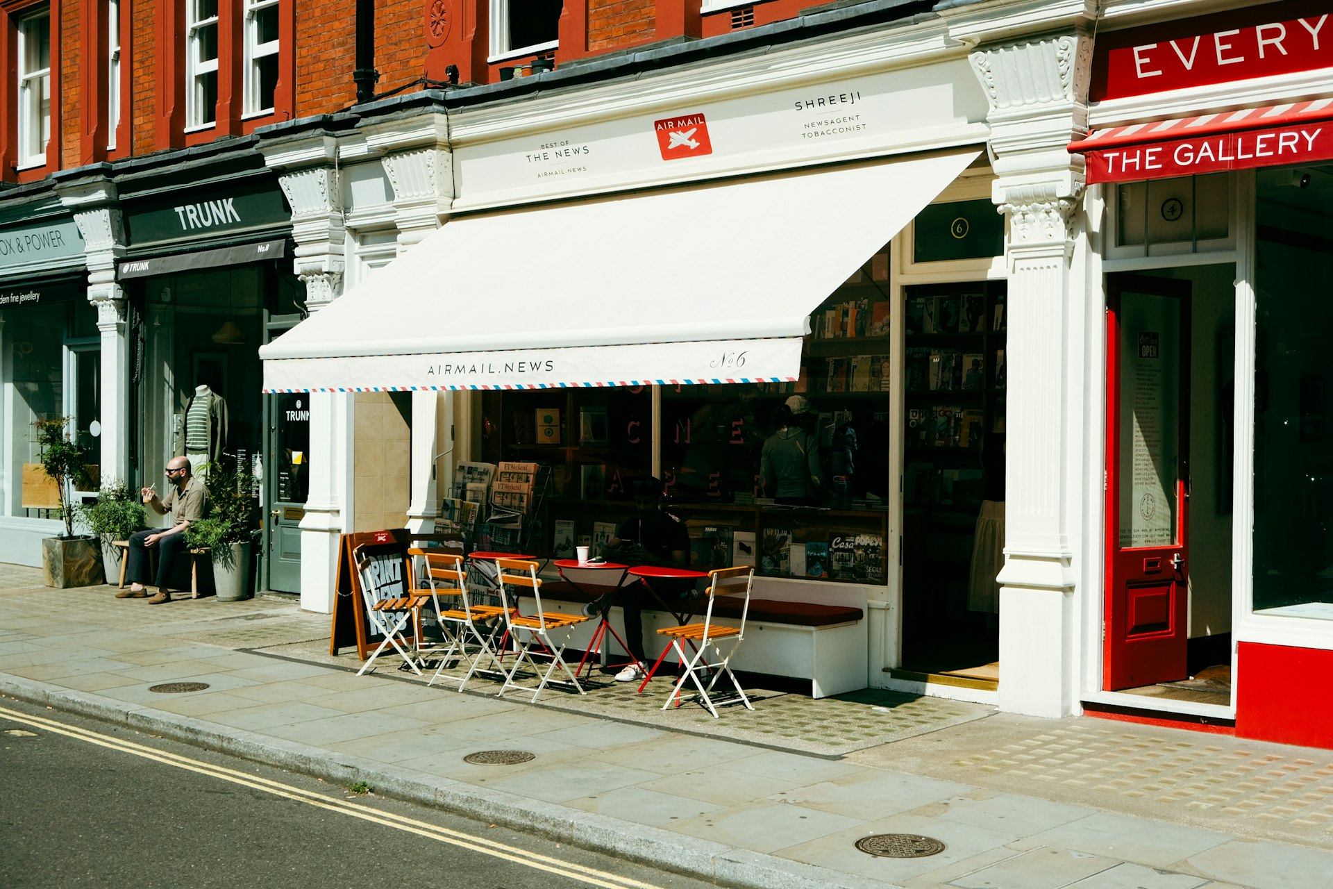 A Marylebone shopfront with a white awning and café seating